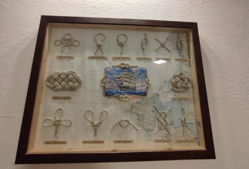 a framed picture of scissors and a map at Rossese in Riomaggiore