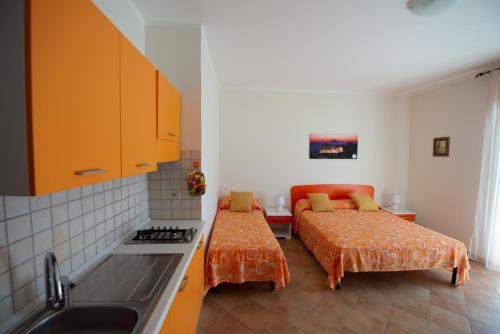 a kitchen with two beds and a couch in it at Appartamenti Attilio in Tropea