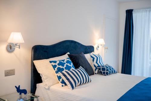 a bedroom with a bed with blue and white pillows at BeB Palazzo Mancini in Minori