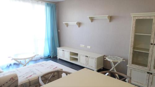 a room with two beds and a table and chairs at Captain's Island Deluxe in Chernomorets