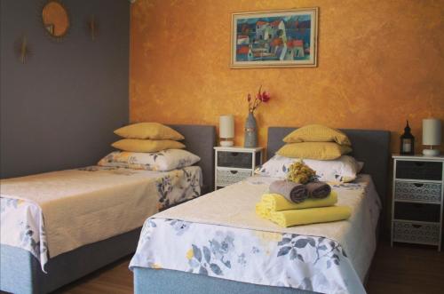 a bedroom with two beds with towels on them at Marina Guesthouse in Korčula