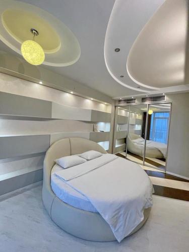 a bedroom with a large bed and a large mirror at Most City Apart-Hotel in Dnipro