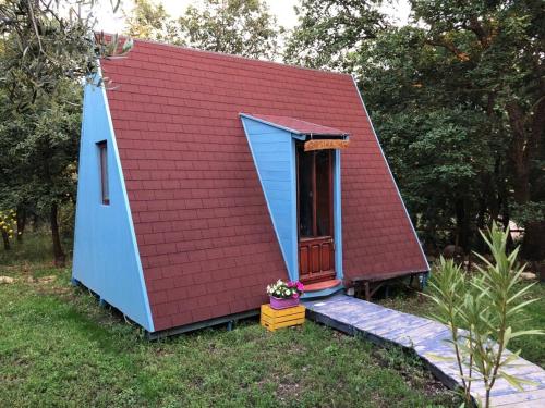a red roofed shed with a red roof at HAPPY GLAMPING MADONIE in Polizzi Generosa