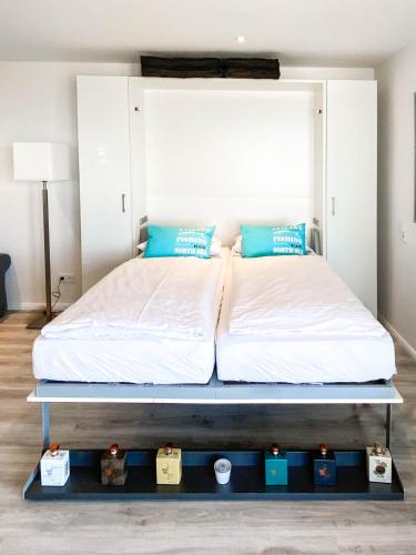 a bed on a platform in a bedroom at WellenRausch Living "Nock" in Travemünde