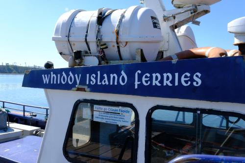 a boat with a sign on the top of it at Whiddy School House Accommodation in Ladyʼs Odell