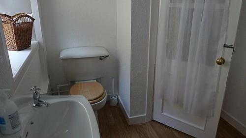 a small bathroom with a toilet and a shower at Keeper's Cottage in Lochgilphead