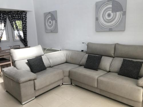 a living room with a couch and a table at Villa Pagel - A Murcia Holiday Rentals Property in Roldán