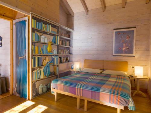 a bedroom with a bed and a book shelf at Agriturismo Natta Di Monte Tabor in Celle Ligure