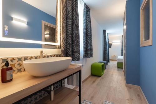 a bathroom with a large white bowl sink on a counter at lillil - Popping Holiday in Riva del Garda