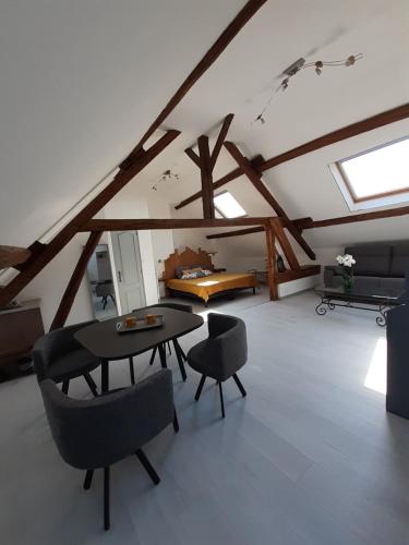 a room with a table and chairs in a attic at LA BONNE ADRESSE 
