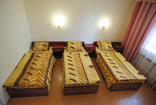 a group of beds in a room at Hotel Star in Stryi