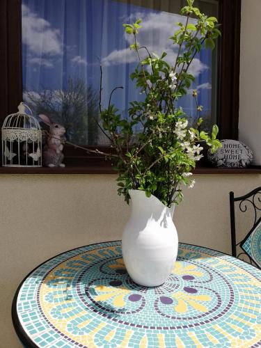 a white vase sitting on top of a table at Vila Chic M in Moieciu de Jos