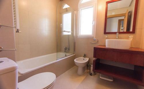 a bathroom with a sink and a toilet and a tub at Casa Jurel - A Murcia Holiday Rentals Property in Roldán