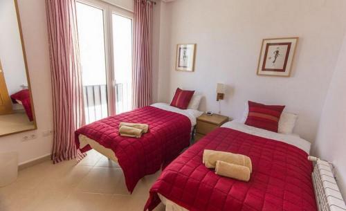 a bedroom with two beds and a window at Casa Jurel - A Murcia Holiday Rentals Property in Roldán