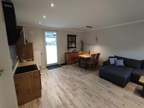 a living room with a couch and a table at Ferienwohnung Südkurve in Briedel