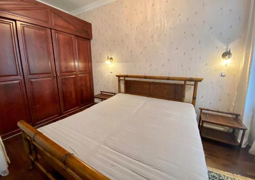 マリアーンスケー・ラーズニェにあるApartment Purkynovaのベッドルーム1室(大型ベッド1台、木製キャビネット付)