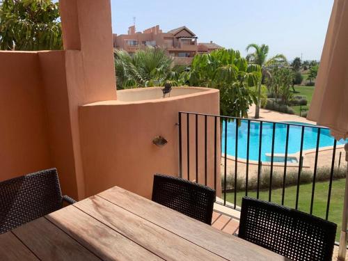 a table and chairs on a balcony with a pool at PedroRoca 285938-A Murcia Holiday Rentals Property in Torre-Pacheco