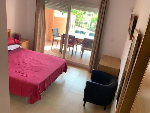 a bedroom with a bed and a chair and a table at PedroRoca 285938-A Murcia Holiday Rentals Property in Torre-Pacheco