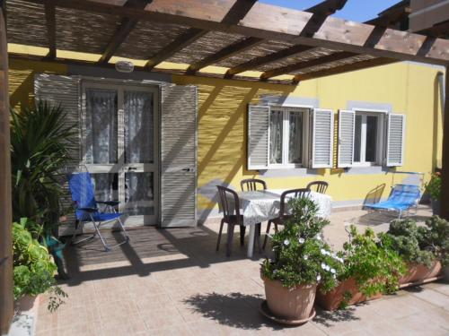 a patio with a table and chairs on it at Appartamenti Claudia Rio in Rio Marina