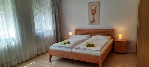 a bedroom with a bed with two yellow pillows on it at Haus Wegleitner in Apetlon