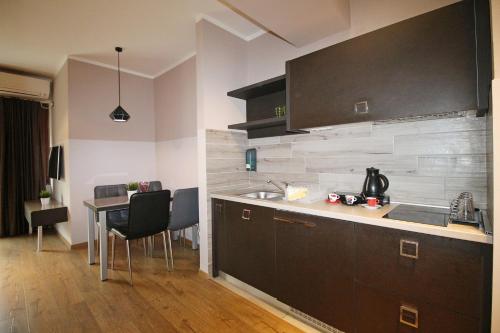 a kitchen with a sink and a table in a room at Luxury Skopje Apartments in Skopje