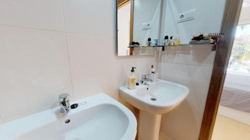 a white bathroom with a sink and a mirror at Casa Kazamour - A Murcia Holiday Rentals Property in Torre-Pacheco