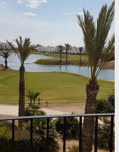 a view of a golf course with palm trees and a pond at Emperador 302919-A Murcia Holiday Rentals Property in Roldán