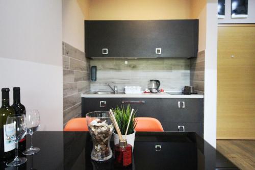 a kitchen with a table with glasses of wine at Luxury Skopje Apartments in Skopje