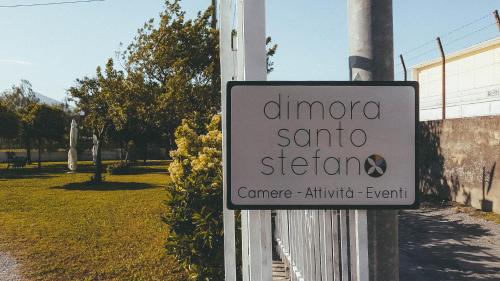 a white sign on a pole in a park at Dimora Santo Stefano in Pompei