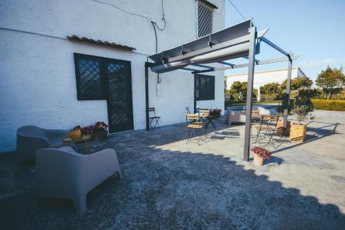 a patio with chairs and tables in front of a building at Dimora Santo Stefano in Pompei