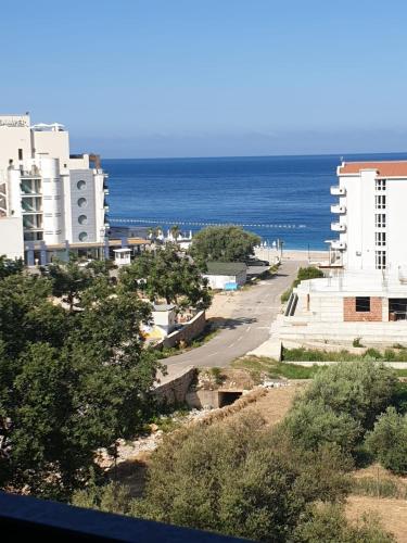 a view of the beach and buildings and the ocean at Apartmani Aida in Dobra Voda