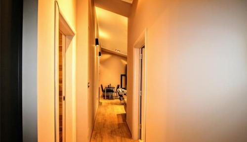 a hallway leading to a dining room with a table at Luxury Skopje Apartments in Skopje