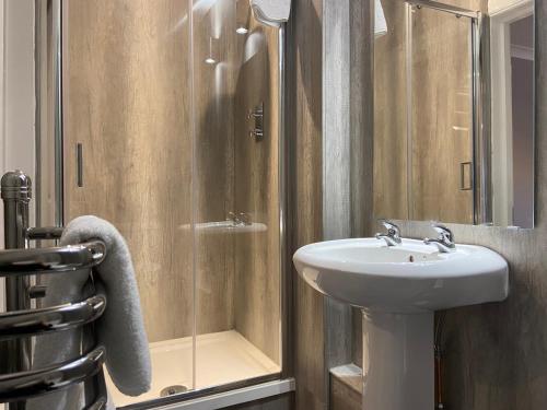 a bathroom with a sink and a shower at Barony Castle Hotel in Peebles