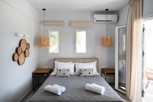 a bedroom with a bed with two towels on it at Drios Luxury Studios in Drios