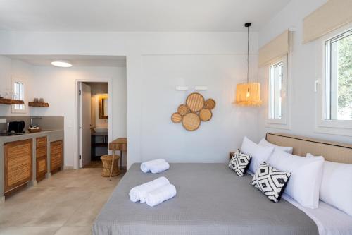 a bedroom with a bed with towels on it at Drios Luxury Studios in Drios