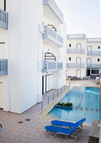 a swimming pool in the middle of a building at Popi Hotel Apartments in Agia Marina Nea Kydonias