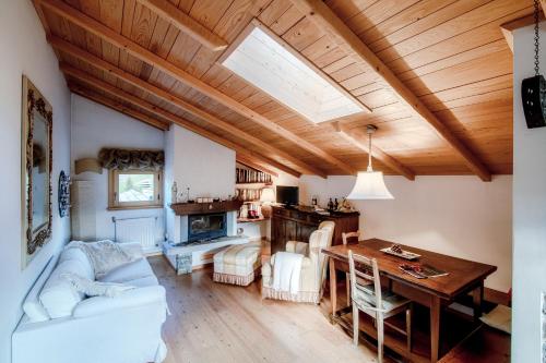 sala de estar con sofá blanco y mesa en Charming Mountain Penthouse, en Aprica