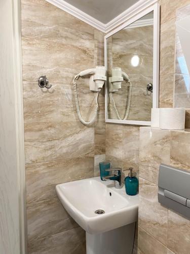 a bathroom with a sink and a mirror at Morskyi 487 in Zatoka