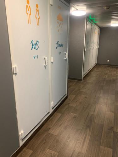a row of lockers in a room with wood floors at hotelF1 Villepinte Parc des Expositions in Villepinte