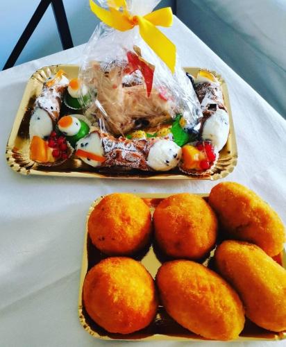 two trays of food on a table with food on it at L'angolo di Rosa in Campofelice di Roccella