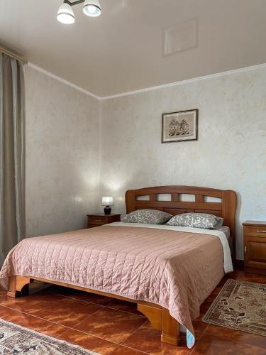 a bedroom with a bed with a pink bedspread at Morskyi 487 in Zatoka