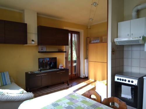 a kitchen with a table and a stove top oven at Casa Bella Vista in Baveno
