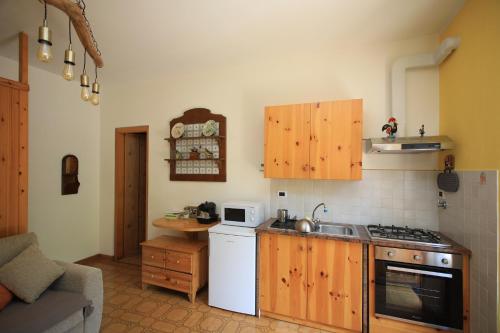 a kitchen with a sink and a stove top oven at Green Riviera Case Vacanza in Borzonasca