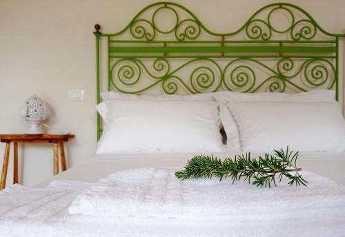 a bed with a green headboard with a christmas tree on it at Giardino Frannicola in Maglie