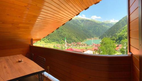 a window in a wooden room with a view of a mountain at İmera Suite Otel in Uzungöl