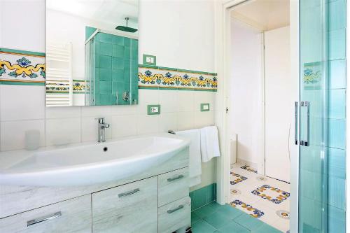 a white bathroom with a sink and a shower at Angolo di Paradiso Sorrento Coast in Moiano