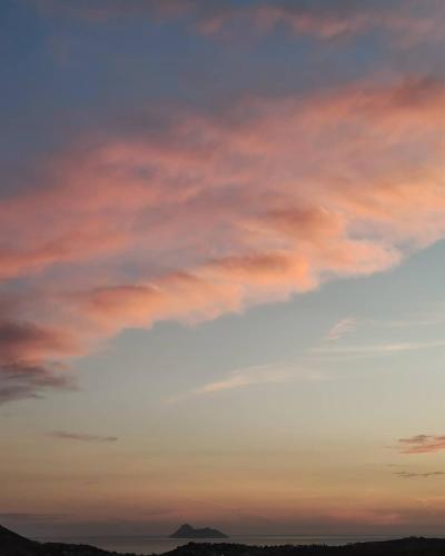 a cloudy sky at sunset with a mountain in the background at House of Sunset - Tranquility - View - Relaxation in Sívas