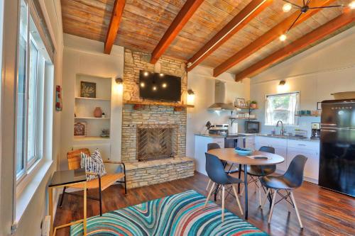 a kitchen with a table and chairs and a fireplace at Millies Cottages Unit 5 - Josephine in Canyon Lake