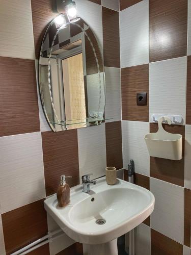 a bathroom with a sink and a mirror at Lovin's Rooms in Tuzla