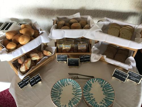a table with different types of bread and pastries at Villa Greta Hotel Rooms & Suites in Taormina